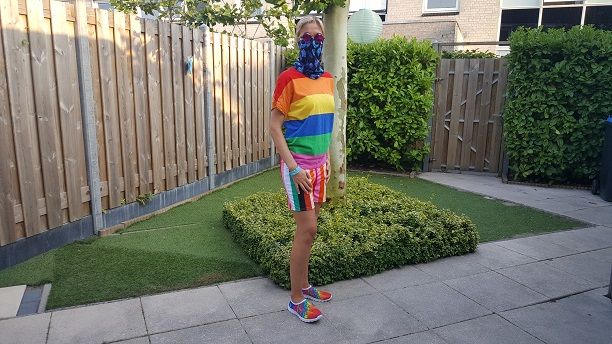 A woman is modeling the women's rave clothing, top, hotpants, and shoes, in landscape orientation.